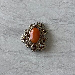 Ornate Orange and Brown Brooch with Intricate Metalwork
